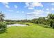 Spacious backyard with pond view and lush greenery at 212 Excalibur Ct, Brandon, FL 33511