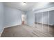 Light blue bedroom with mirrored closet and view of another room at 212 Excalibur Ct, Brandon, FL 33511