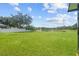 Spacious backyard with a pond view and lush green lawn at 212 Excalibur Ct, Brandon, FL 33511