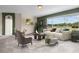 Living room with large windows, green accent wall, and neutral furniture at 212 Excalibur Ct, Brandon, FL 33511