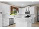 Bright kitchen featuring white cabinets, stainless steel appliances, and an island at 212 Excalibur Ct, Brandon, FL 33511