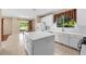 Eat-in kitchen with island, white cabinets, and sliding door access to backyard at 212 Excalibur Ct, Brandon, FL 33511