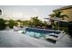 Modern rectangular pool with white lounge chairs at 8295 Cheyenne Dr, Seminole, FL 33777