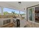 Outdoor kitchen with granite countertop and stainless steel appliances at 8295 Cheyenne Dr, Seminole, FL 33777