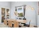 Elegant dining room with large window and modern light fixture at 8295 Cheyenne Dr, Seminole, FL 33777