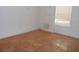 Small bedroom with tile floors and a window at 7101 Green St, New Port Richey, FL 34652