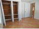 Bedroom with wood closet doors and tile floors at 7101 Green St, New Port Richey, FL 34652