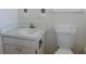 Bathroom with toilet, sink, and white tile at 7101 Green St, New Port Richey, FL 34652
