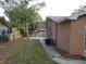 View of the home's side yard with fence and AC unit at 7101 Green St, New Port Richey, FL 34652