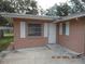 Side view of the house exterior, showing a door and window at 7101 Green St, New Port Richey, FL 34652