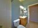 Second bathroom with shower, toilet and wood vanity at 7827 Starfire Way, New Port Richey, FL 34654