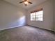 Simple bedroom with carpeted floors and window at 7827 Starfire Way, New Port Richey, FL 34654