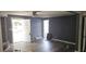 Spacious living room with wood-look floors and an exterior door at 4375 Lindsey Loop, Dover, FL 33527