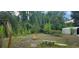 Backyard with wooden bench and overgrown vegetation at 4375 Lindsey Loop, Dover, FL 33527