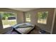 Bedroom with large windows and a mattress on the floor at 4375 Lindsey Loop, Dover, FL 33527