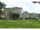 Large backyard with screened in pool, green grass and a landscaped garden at 5308 Cedarshake Ln, Valrico, FL 33596