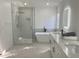 Bright bathroom with a glass-enclosed shower, freestanding tub, and a modern vanity at 5308 Cedarshake Ln, Valrico, FL 33596