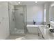 Bathroom showcasing a glass-enclosed shower, a freestanding tub, and a modern vanity at 5308 Cedarshake Ln, Valrico, FL 33596