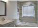 Bathroom featuring shower/tub combo with modern tile and shower niche at 5308 Cedarshake Ln, Valrico, FL 33596