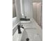 Bathroom featuring double sinks, quartz countertops, and lighted mirrors at 5308 Cedarshake Ln, Valrico, FL 33596