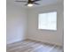 Minimalist bedroom with light wood floors, neutral walls, and a large window at 5308 Cedarshake Ln, Valrico, FL 33596