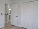 Bright bedroom with light wood-look flooring, closet and doorway to bathroom at 5308 Cedarshake Ln, Valrico, FL 33596