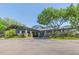 Beautifully landscaped clubhouse featuring stone columns and covered entrance, perfect for community gatherings at 5308 Cedarshake Ln, Valrico, FL 33596