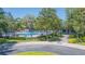 Community pool with mature landscaping, lounge seating, and secure fencing, perfect for Gathering recreation at 5308 Cedarshake Ln, Valrico, FL 33596