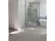 Modern shower with a glass enclosure, rain shower head, and marble tile at 5308 Cedarshake Ln, Valrico, FL 33596