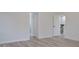 Bedroom with wood-look floors and access to bathroom at 5308 Cedarshake Ln, Valrico, FL 33596