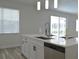 Kitchen island with quartz countertops, stainless steel dishwasher, and modern faucet at 5308 Cedarshake Ln, Valrico, FL 33596
