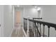 Upstairs hallway with wood-look floors and railing at 5308 Cedarshake Ln, Valrico, FL 33596