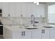 White kitchen island with quartz countertops and modern fixtures at 5308 Cedarshake Ln, Valrico, FL 33596