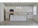 Modern kitchen with white shaker cabinets, quartz countertops and island at 5308 Cedarshake Ln, Valrico, FL 33596