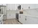Sleek kitchen with white cabinetry, stainless steel appliances, and quartz countertops at 5308 Cedarshake Ln, Valrico, FL 33596