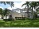 Two-story house with white siding, lush landscaping, and a large yard at 5308 Cedarshake Ln, Valrico, FL 33596