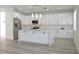 Modern kitchen with white cabinets, quartz countertops and island at 5308 Cedarshake Ln, Valrico, FL 33596