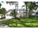 Two-story house with white siding, lush landscaping, and a large yard at 5308 Cedarshake Ln, Valrico, FL 33596