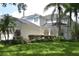 Two-story house with white siding, lush landscaping, and a large yard at 5308 Cedarshake Ln, Valrico, FL 33596