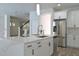 Modern kitchen with large island, stainless steel appliances, and white cabinets at 5308 Cedarshake Ln, Valrico, FL 33596