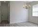 Bright dining room with chandelier and wood-look floors at 5308 Cedarshake Ln, Valrico, FL 33596