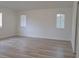 Spacious bedroom with wood-look floors and two windows at 5308 Cedarshake Ln, Valrico, FL 33596