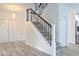 Modern staircase with gray steps and black iron railing at 5308 Cedarshake Ln, Valrico, FL 33596