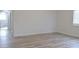 Bedroom with wood-look floors and access to bathroom at 5308 Cedarshake Ln, Valrico, FL 33596