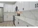 Modern kitchen with white cabinets, quartz countertops, and stainless steel appliances at 5308 Cedarshake Ln, Valrico, FL 33596