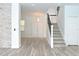 Light and spacious entryway with modern staircase and wood-look floors at 5308 Cedarshake Ln, Valrico, FL 33596
