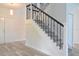 Modern staircase with gray steps and black iron railing at 5308 Cedarshake Ln, Valrico, FL 33596