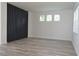 Bright bedroom with wood-look floors and modern wall accent at 5308 Cedarshake Ln, Valrico, FL 33596