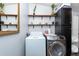 Bright laundry room, washer, dryer, and ample shelving at 4622 Paloverde Dr, New Port Richey, FL 34652