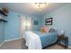 Bedroom with light blue bedding and floating shelves at 4622 Paloverde Dr, New Port Richey, FL 34652